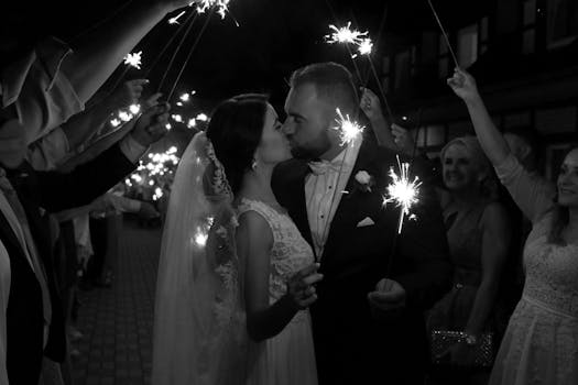 pexels-photo-1646730-1646730 Bride and groom share a romantic kiss with sparklers, creating a magical wedding moment.